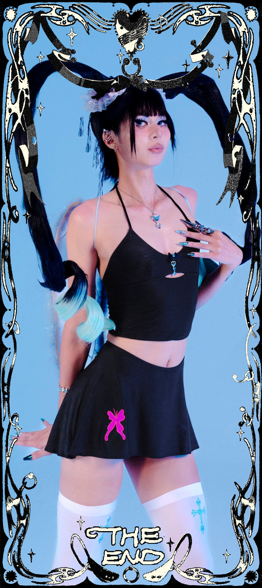 Person in black outfit with decorative elements on a blue background