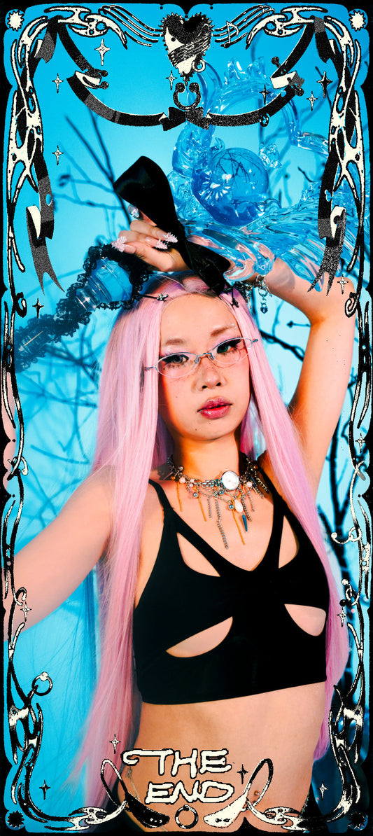 Person with pink hair and black top against a blue abstract background with 'The End' text.