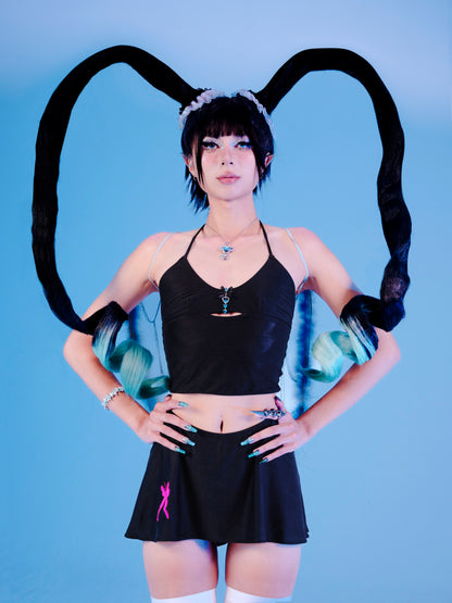 Person wearing a black outfit with bunny ears and a skirt on a blue background